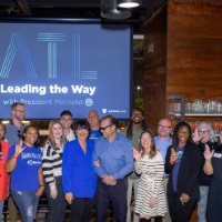 Group photo of Leading the Way to Atlanta event attendees doing the anchor up symbol